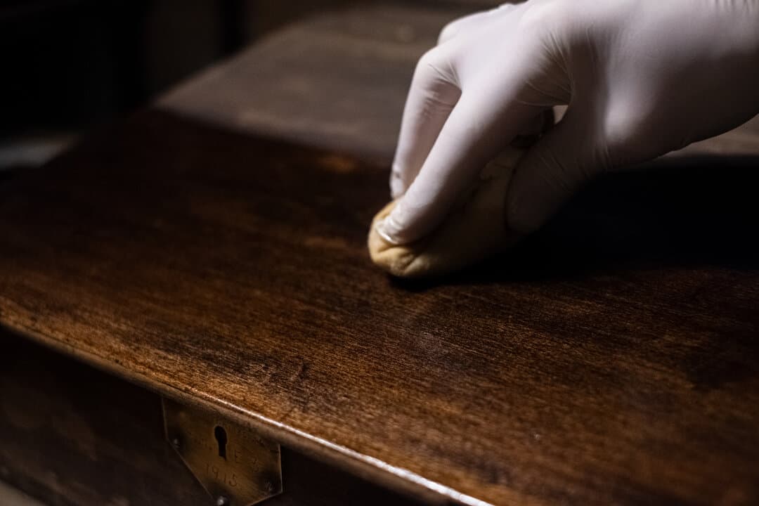 Hand-applying polish to antique furniture